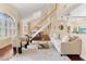 Bright and airy living room featuring a staircase, hardwood floors, and a view of the dining area at 3604 Shell Cove Ln, Orlando, FL 32817