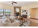 Inviting living room features a brick fireplace, stylish decor, and serene views of the lake and backyard at 3604 Shell Cove Ln, Orlando, FL 32817