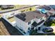 Aerial view of home with solar panels, fenced yard, well-maintained lawn, and driveway at 376 Willet Street Willet St, Haines City, FL 33844