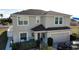 Two story home featuring an attached garage, manicured shrubbery, and neutral stucco exterior at 376 Willet Street Willet St, Haines City, FL 33844