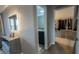 Bright hallway featuring a vanity with lighted mirror, plus a view of a walk-in closet and ensuite bath at 376 Willet Street Willet St, Haines City, FL 33844