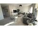 Open concept living room featuring a decorative textured wall and gray furnishings at 376 Willet Street Willet St, Haines City, FL 33844