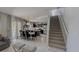 Open concept living room and dining area adjacent to the modern kitchen and staircase at 376 Willet Street Willet St, Haines City, FL 33844