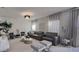 Living room featuring a textured wall, gray sofa, and decorative chandelier at 376 Willet Street Willet St, Haines City, FL 33844