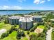 Experience luxury living from above in this aerial view, surrounded by lush golf course greenery and stunning water views at 4 Oceans West Blvd # 502D, Daytona Beach Shores, FL 32118