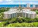 Stunning aerial view of a beachfront condo complex with lush landscaping and ocean views on a sunny day at 4 Oceans West Blvd # 502D, Daytona Beach Shores, FL 32118