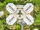 Breathtaking aerial shot of a condominium complex surrounded by a golf course, showcasing luxury living amidst nature at 4 Oceans West Blvd # 502D, Daytona Beach Shores, FL 32118