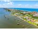 Breathtaking aerial view showcasing waterfront homes with private docks along a scenic coastline with blue skies and calm waters at 4 Oceans West Blvd # 502D, Daytona Beach Shores, FL 32118