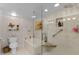 Well-lit bathroom featuring a soaking tub, glass shower, and modern fixtures at 4 Oceans West Blvd # 502D, Daytona Beach Shores, FL 32118