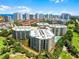 Beautiful exterior view of a multi-story building, surrounded by lush greenery, and showcasing a coastal and golf course view at 4 Oceans West Blvd # 502D, Daytona Beach Shores, FL 32118