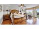 Spacious bedroom with hardwood floors, a wooden bed, and a bright sitting area at 4 Oceans West Blvd # 502D, Daytona Beach Shores, FL 32118