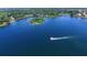 Aerial view featuring an island, boat and homes on a beautiful body of water at 4415 Raymar Dr, Orlando, FL 32839