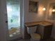 Bathroom featuring decorative glass door, toilet, sink, and pendant lights at 4415 Raymar Dr, Orlando, FL 32839