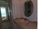 Bathroom showcasing unique tile accents, decorative mirror, and stylish sink at 4415 Raymar Dr, Orlando, FL 32839