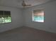 Empty bedroom with carpet, two windows, and a ceiling fan at 4415 Raymar Dr, Orlando, FL 32839