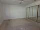 Spacious bedroom featuring ceiling fan and mirrored closet doors at 4415 Raymar Dr, Orlando, FL 32839