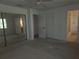 Bedroom featuring mirrored closet doors, ceiling fan, and entry to bath at 4415 Raymar Dr, Orlando, FL 32839