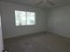 Bedroom with carpet, ceiling fan, and view from a large window at 4415 Raymar Dr, Orlando, FL 32839