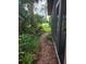 Exterior side view showing a brick pathway along a screened-in porch at 4415 Raymar Dr, Orlando, FL 32839