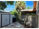 Exterior shot featuring a shed, trash cans, privacy lattice, and tropical greenery at 4415 Raymar Dr, Orlando, FL 32839