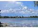 Picturesque view of the tranquil lake with clouds reflecting on the water on a sunny day at 4415 Raymar Dr, Orlando, FL 32839