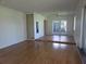 Large open living room with hardwood floors, ceiling fan, and glass doors to the outside at 4415 Raymar Dr, Orlando, FL 32839
