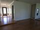 Hardwood living room displaying natural light and an entry door at 4415 Raymar Dr, Orlando, FL 32839