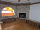 Living room with hardwood floors, a brick fireplace, and an archway to the kitchen at 4415 Raymar Dr, Orlando, FL 32839