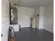 Unfinished utility room with water heater, storage and painted concrete block walls at 4415 Raymar Dr, Orlando, FL 32839