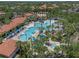 Aerial view of resort-style community pool with lush landscaping, lounge chairs, and splash pad at 5172 Oakbourne Ave, Davenport, FL 33837