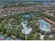 Community aerial view featuring a lazy river, pool, tennis courts, and residential area at 5172 Oakbourne Ave, Davenport, FL 33837