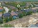 Aerial view of houses with screened-in pools, solar panels and lush landscaping at 5172 Oakbourne Ave, Davenport, FL 33837