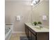Bathroom featuring double sinks, a bath and neutral walls at 5172 Oakbourne Ave, Davenport, FL 33837