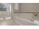 Clean bathroom featuring soaking tub with mosaic tile accents and a glass-enclosed shower at 5172 Oakbourne Ave, Davenport, FL 33837