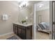 Bathroom with double sink vanity, neutral walls, and tile floor at 5172 Oakbourne Ave, Davenport, FL 33837