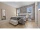 Comfortable bedroom featuring a king bed, stylish accent wall, and neutral tones at 5172 Oakbourne Ave, Davenport, FL 33837