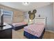 Charming bedroom featuring two twin beds and fun Disney-themed decor at 5172 Oakbourne Ave, Davenport, FL 33837