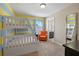 View of bedroom with bunk beds, orange chair, and an ensuite bathroom at 5172 Oakbourne Ave, Davenport, FL 33837