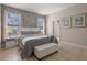 Bright bedroom featuring a comfortable king bed, neutral color palette, and stylish accent wall at 5172 Oakbourne Ave, Davenport, FL 33837