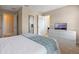 Bedroom featuring dresser with TV, and doorway into bathroom at 5172 Oakbourne Ave, Davenport, FL 33837
