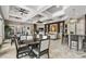 Clubhouse room with tables, chairs, television, modern lighting and decorative columns at 5172 Oakbourne Ave, Davenport, FL 33837