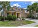 Beautiful two-story home with a lush front lawn, mature palm trees, and a two-car garage, perfect curb appeal at 5172 Oakbourne Ave, Davenport, FL 33837