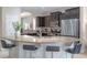 Open-concept kitchen with granite countertops, stainless steel appliances, and a breakfast bar with seating at 5172 Oakbourne Ave, Davenport, FL 33837