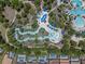 Overhead shot of a winding lazy river with lounge areas and lush landscaping at 5172 Oakbourne Ave, Davenport, FL 33837