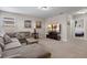Relaxing carpeted living room area with a sectional sofa and an entertainment center at 5172 Oakbourne Ave, Davenport, FL 33837
