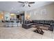 Spacious living room with tile flooring, modern lighting, and a view into the open-concept kitchen at 5172 Oakbourne Ave, Davenport, FL 33837