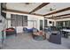 Community lounge area featuring comfortable seating, ceiling fans, fireplace and bar seating at 5172 Oakbourne Ave, Davenport, FL 33837