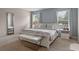 Serene bedroom with light blue walls, white furniture, and soft, natural light at 5172 Oakbourne Ave, Davenport, FL 33837