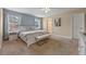 Inviting main bedroom features plush carpet, soft lighting, a white bed frame, and a sitting bench at 5172 Oakbourne Ave, Davenport, FL 33837