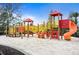 Brightly colored playground with slides and climbing structures set in a sand-filled area for enjoyment at 5172 Oakbourne Ave, Davenport, FL 33837